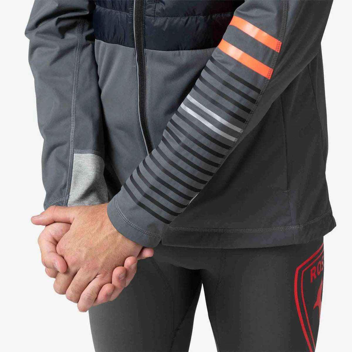 Gray jacket with reflective stripes and a red logo on pants, on a white background