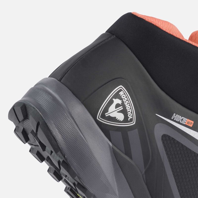 heel of black waterproof hiking boot showing slight amount of orange around the collar and the rossignol logo