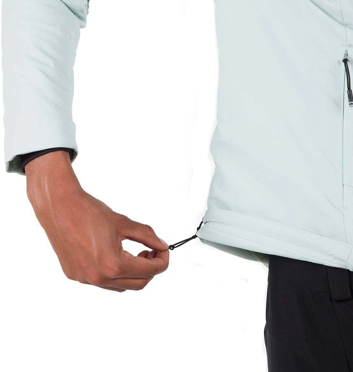 Person adjusting a zipper on a light-colored jacket against a white background