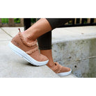 Oofos OOcoozie Low women's White/Chestnut colorway, lifestyle view.