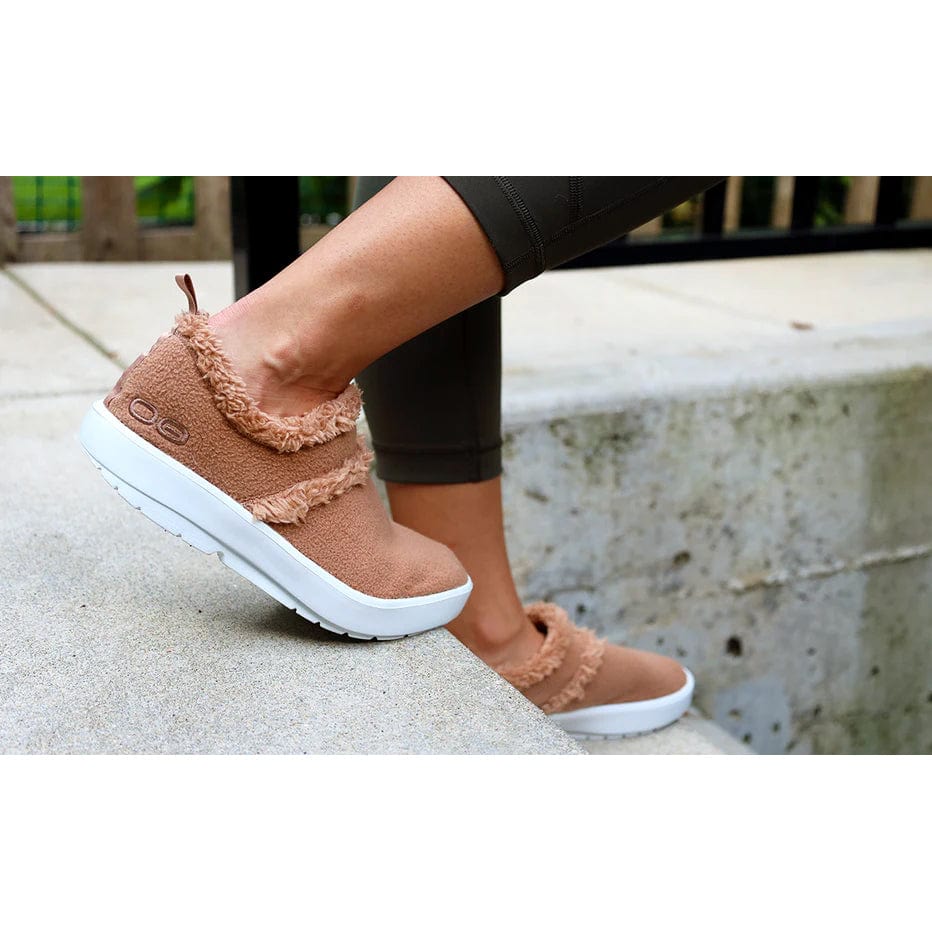 Oofos OOcoozie Low women's White/Chestnut colorway, lifestyle view.