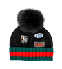 black, green and red hat with 3 ski-related patches and black fox fur pom
