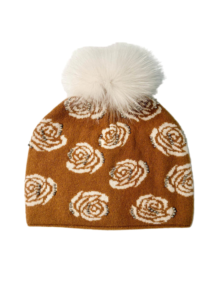 camel colored hat with white roses and pom