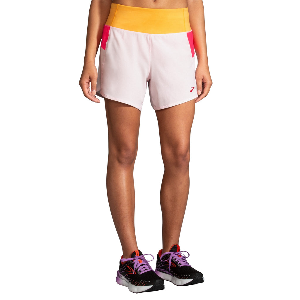 Women's Brooks Chaser 5" Shorts. White/Pink/Orange. Front view.