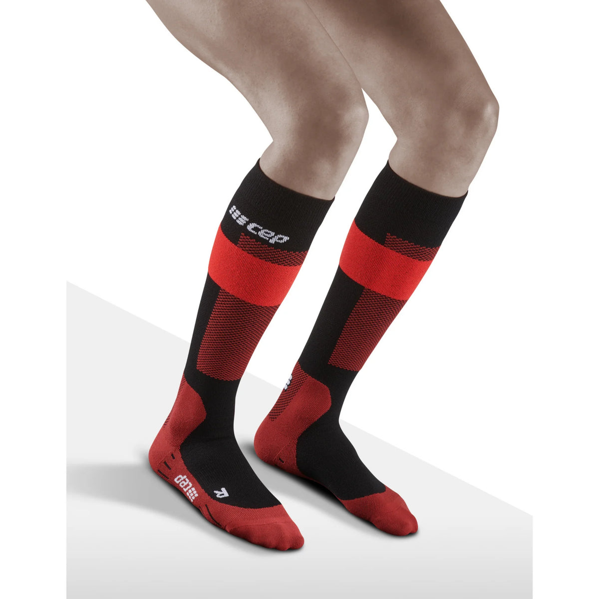 Women's CEP Ski Merino Compression Socks. Red/Black. Lateral view.