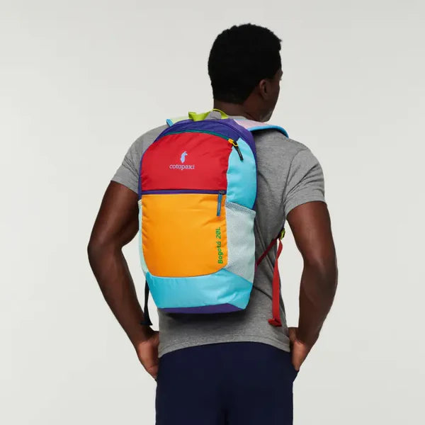 Cotopaxi Bogota 20 Liter backpack del dia. Multi-Color. Model wearing backpack. 