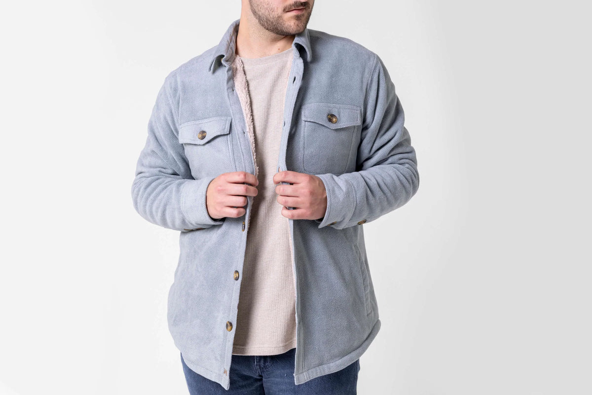 Model wearing the Silver Blue Dakota Grizzly Rocco sherpa-lined shirt jacket open over a beige shirt