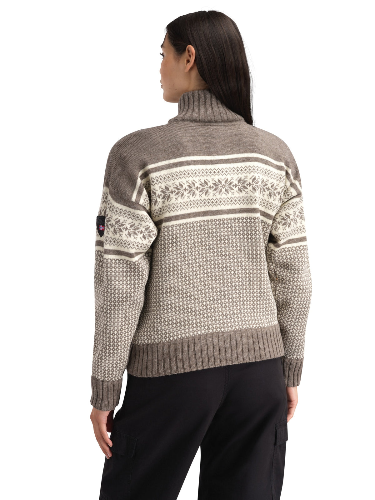 Rear modeled view of the Dale of Norway Vola women's windproof jacket in Mid Brown Melange and Off White, showing traditional Norwegian knit pattern