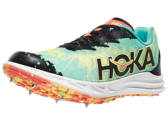 Hoka Crescendo XC Spike. Multicolored upper. White midsole. Lateral view.