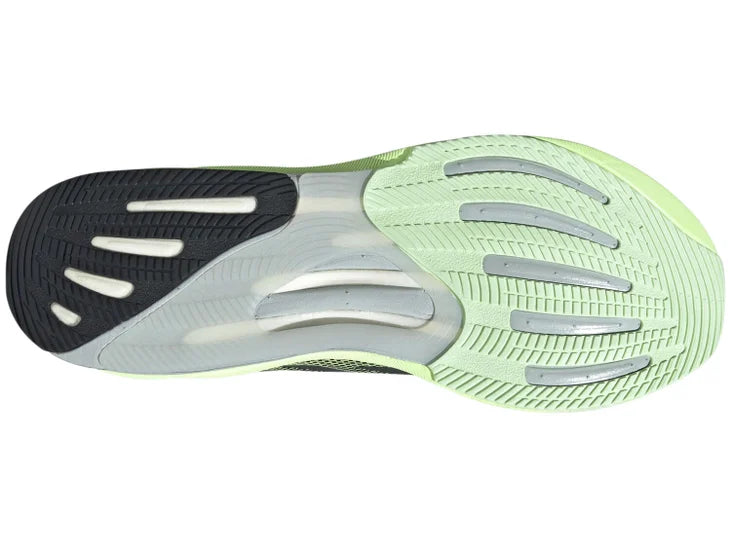 Men's Adidas Supernova Rise - majority black shoe with a bright green fade and green midsole. Sole view including some green, black, and transparent outsole areas