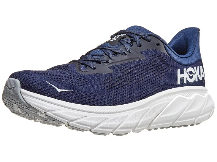 Men's Hoka Arahi 7. Dark Blue upper. White midsole. Lateral view.