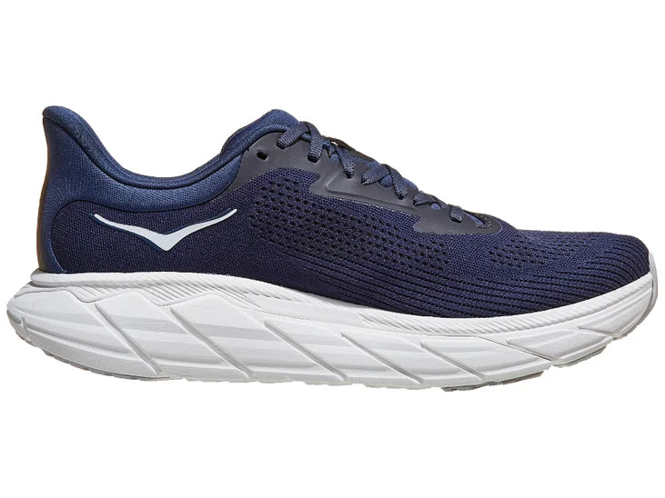 Men's Hoka Arahi 7. Dark Blue upper. White midsole. Medial view.