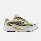Men's New Balance Ellipse. White, black, and gold upper. White and gold midsole. Lateral view.