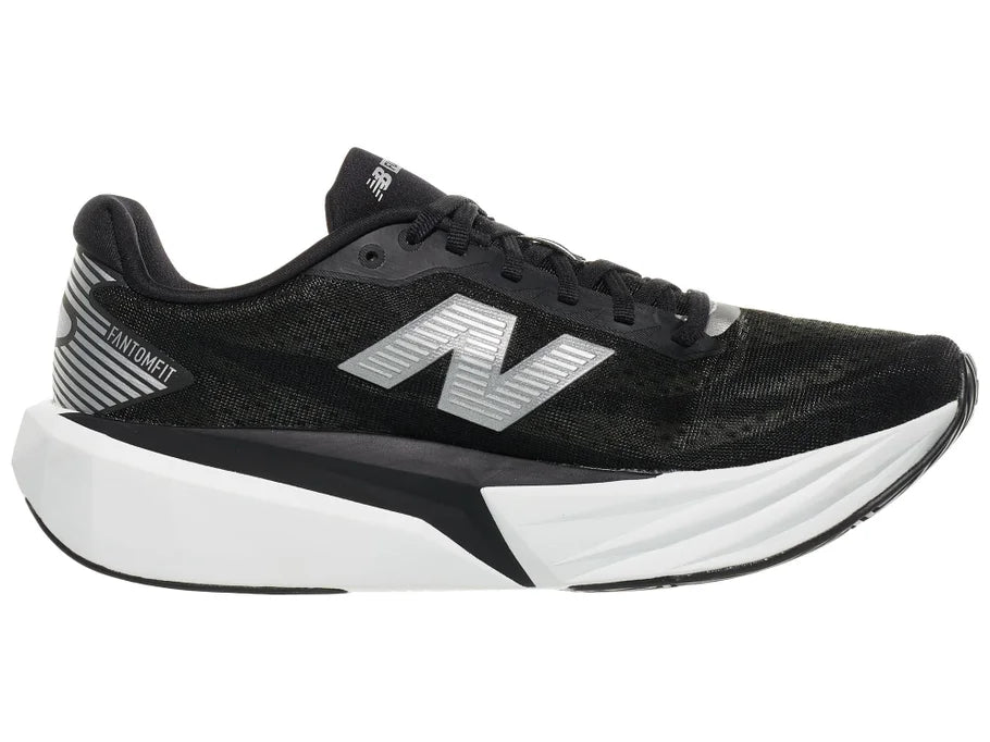 Men's New Balance Rebel v5. Black upper. White midsole. Medial view.