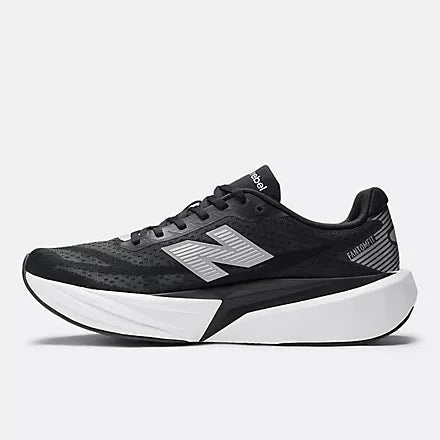 Men's New Balance Rebel v5. Black upper. White midsole. Medial view.