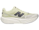 Men's New Balance Rebel v5. Yellow upper. White midsole. Medial view.