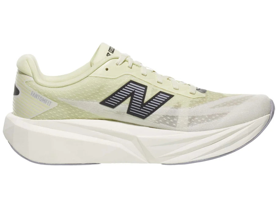 Men's New Balance Rebel v5. Yellow upper. White midsole. Medial view.