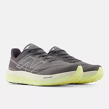 Men's New Balance Vongo v6. Grey upper. Green midsole. Angled lateral view.