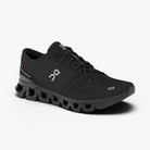 Men's On Cloud X 4. Black upper. Black midsole. Lateral view.