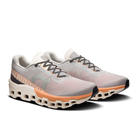 Men's On Cloudmonster 2. Cream and orange upper. Cream and orange midsole. Lateral view.