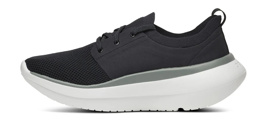 Men's Oofos OOmy Stride. Black upper. White midsole. Medial view.