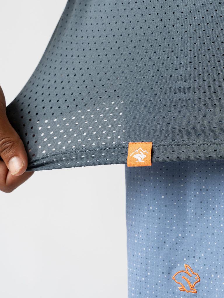 Men's Rabbit EZ Tee Perf SS Trail. Grey and blue color. Orange logo. Front view, up close.