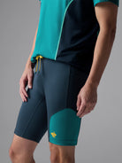 Men's Rabbit Pacer Shorts 8.5in. Navy and turqoise colorway. Side view.