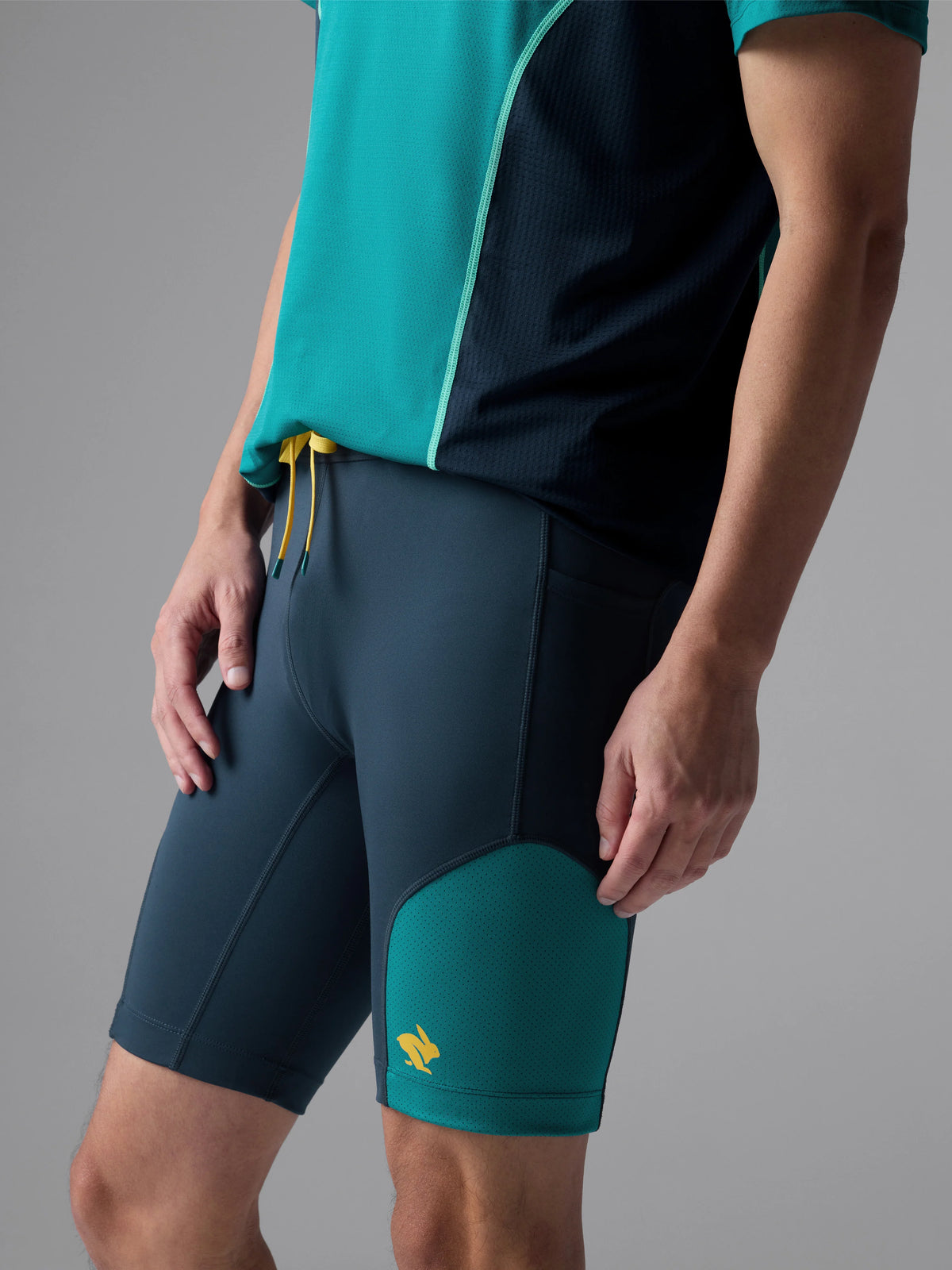 Men's Rabbit Pacer Shorts 8.5in. Navy and turqoise colorway. Side view.