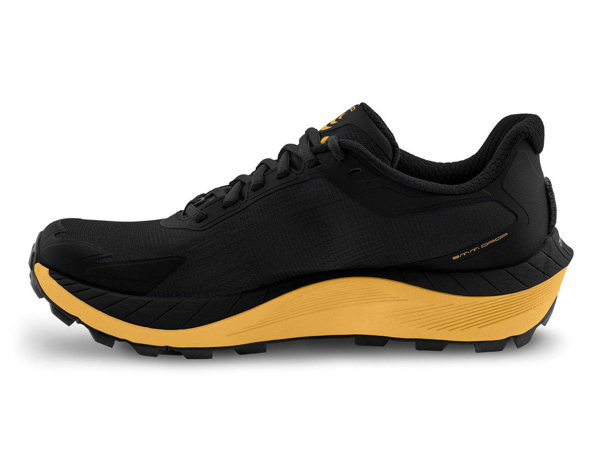 Men's Topo MTN Racer 4. Black upper. Yellow midsole. Medial view.