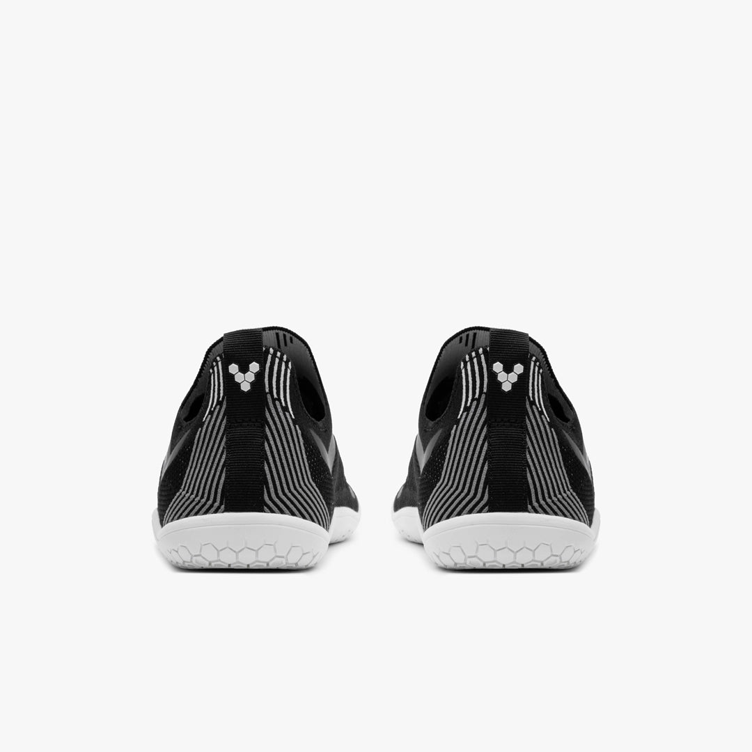 Men's Vivobarefoot Primus Lite Knit. Black upper. White outsole. Rear view.
