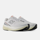 New Balance 1080 v15 men's running shoe in White/Neo Flame — angled view