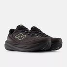 New Balance 1080 v15 women's running shoe in Black/Olivine/Faded Black — angled view