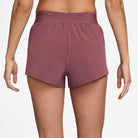 Women's Nike Dri-FIT Mid-Rise 2.5-inch Running Shorts in Pink Smoke, rear view.