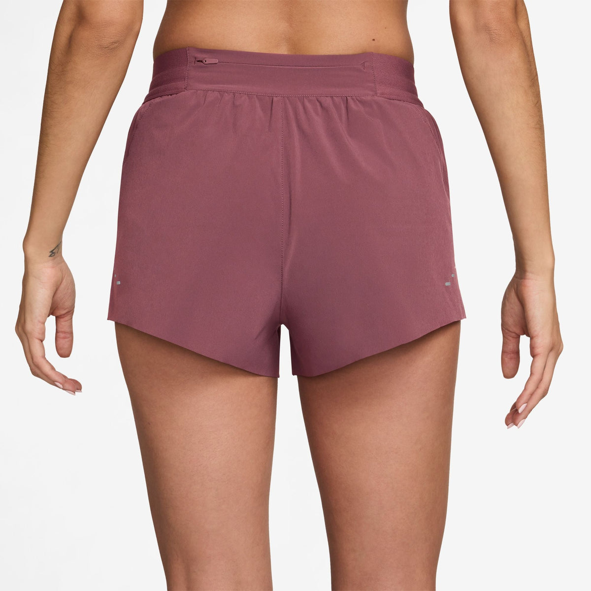 Women's Nike Dri-FIT Mid-Rise 2.5-inch Running Shorts in Pink Smoke, rear view.