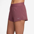 Women's Nike Dri-FIT Mid-Rise 2.5-inch Running Shorts in Pink Smoke, three-quarter view.