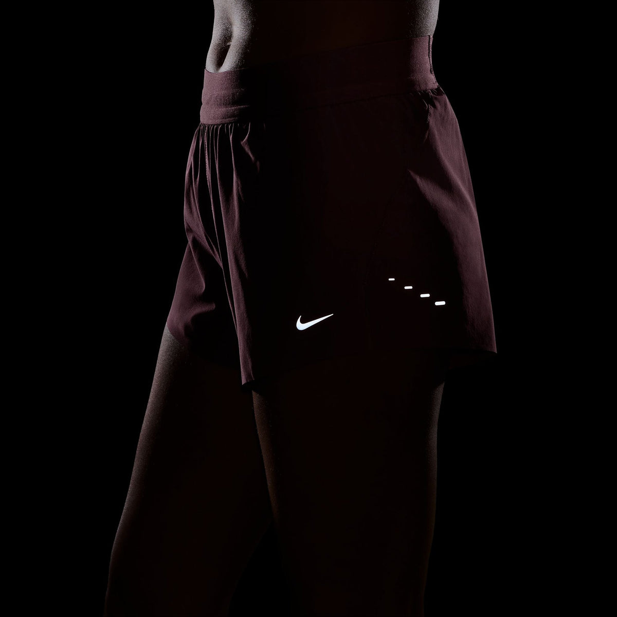 Women's Nike Dri-FIT Mid-Rise 2.5-inch Running Shorts in Pink Smoke, reflective detail.