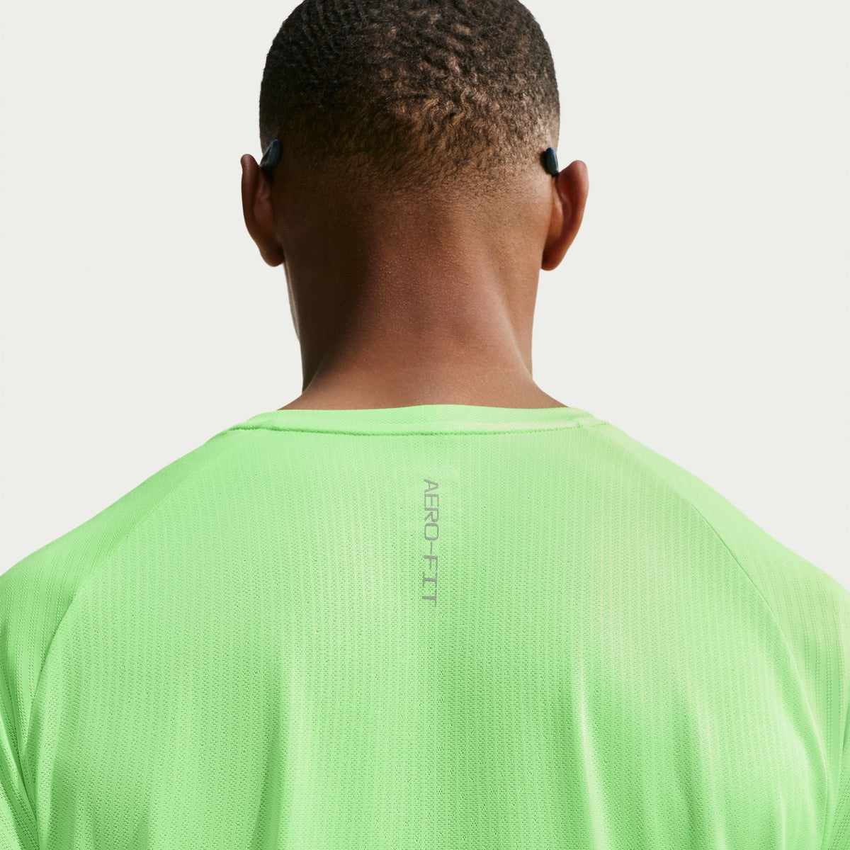 Men's Nike Stride Aero-Fit Short Sleeve Running Shirt in Volt/Light Silver, fabric detail.