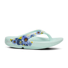 Oofos Oolala Limited Thong. Mint colorway with floral pattern. Lateral view.