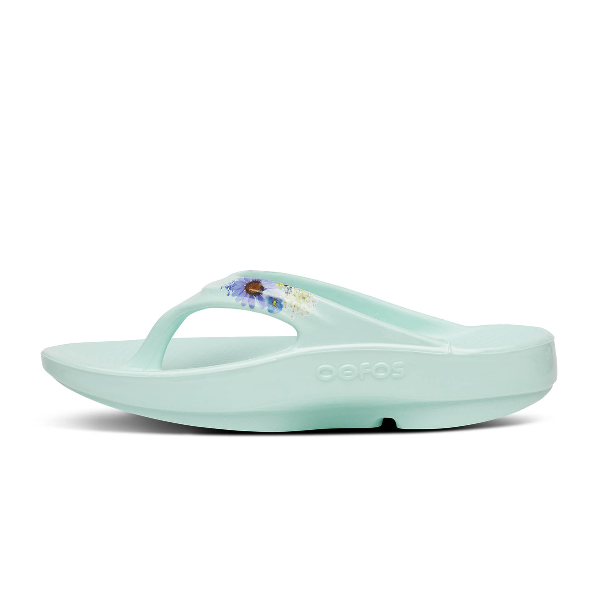 Oofos Oolala Limited Thong. Mint colorway with floral pattern. Medial view.