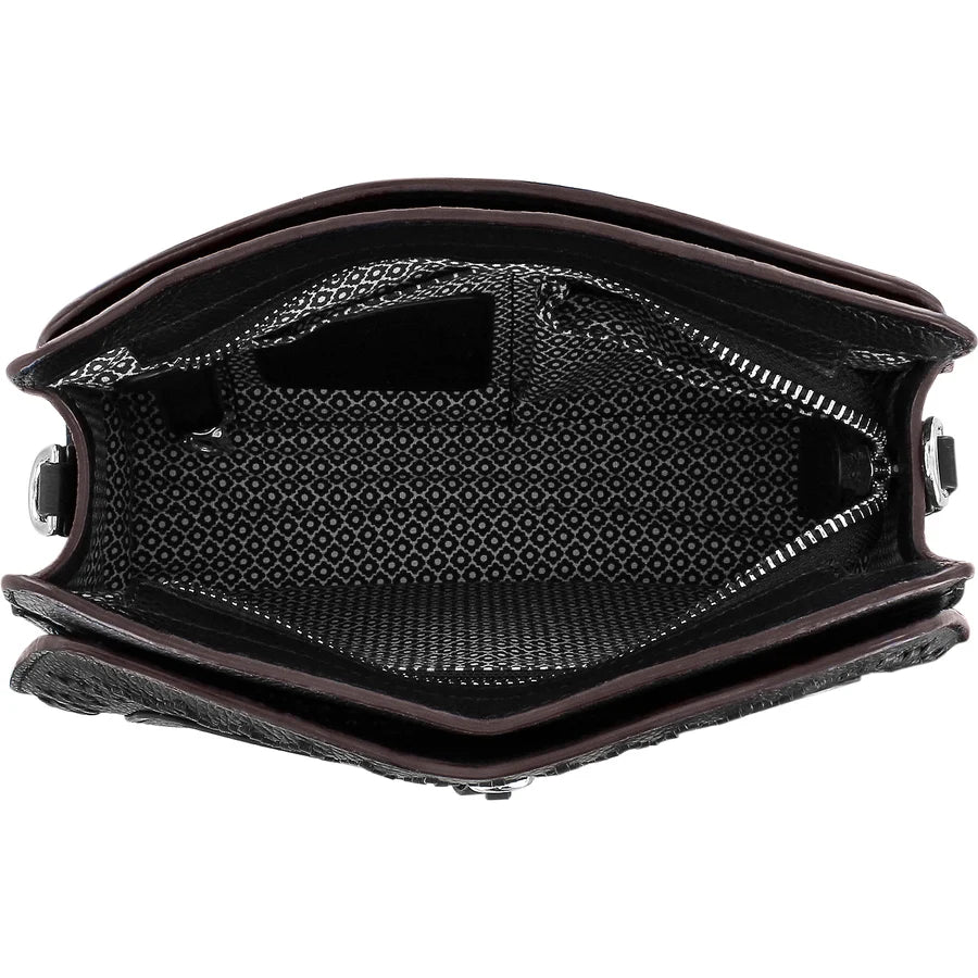 Close-up of a black leather bag with a textured interior on a white background
