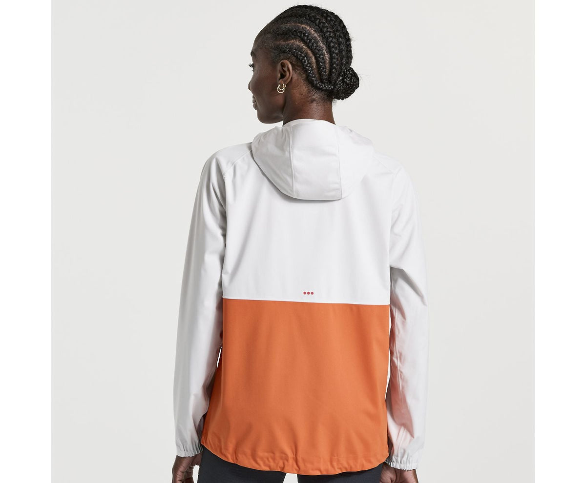 Women's Saucony Boulder Drizzle Jacket. Orange/White. Rear view.