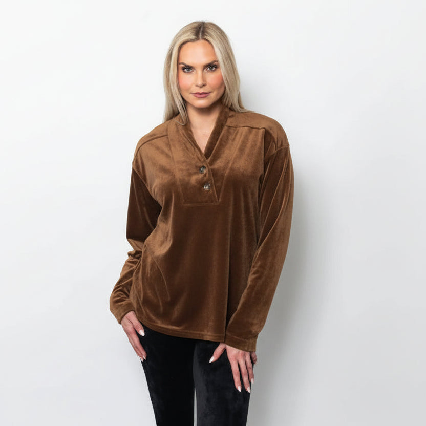 Woman wearing a mocha velvet blouse against a white background