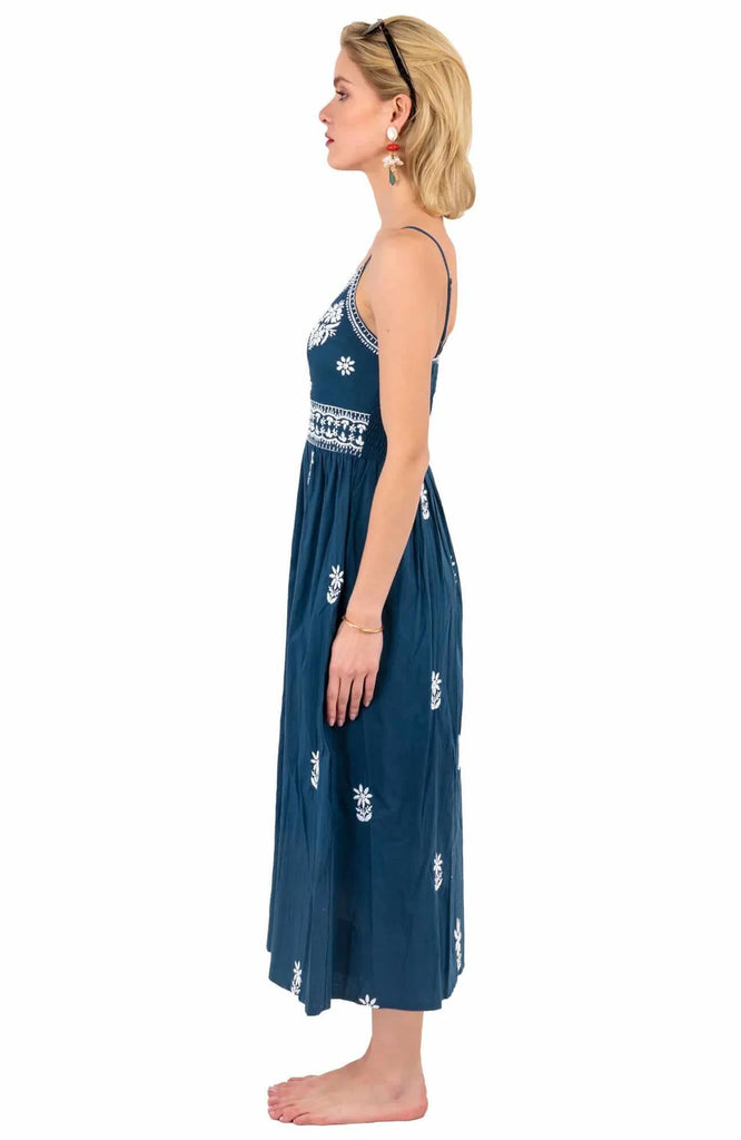 Women's Gretchen Scott Hand Embroidered Midi Dress. Blue with white pattern. Side view.