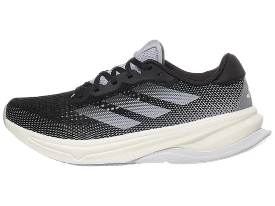 Women's Adidas Supernova Solution. Black upper. Off white midsole. Lateral view.