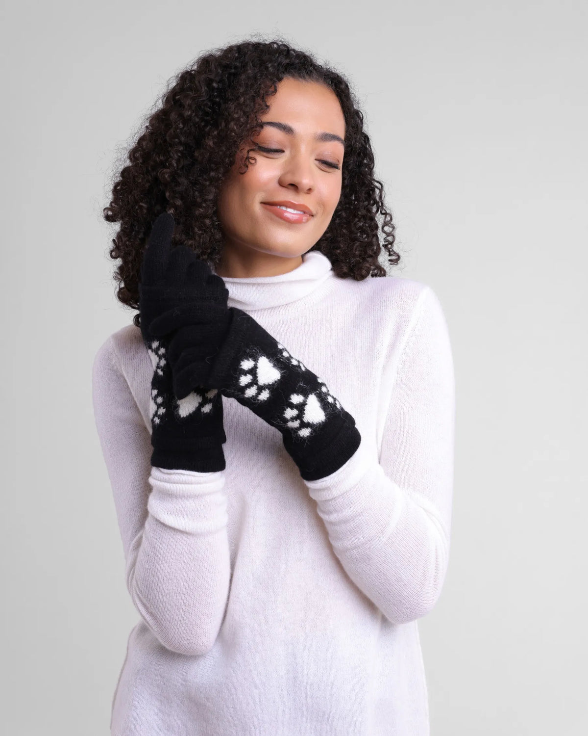 Women's Alashan Cashmere Cashmere/Angora 3-in-1 Paw Print Gloves. Black with white paw print pattern. 