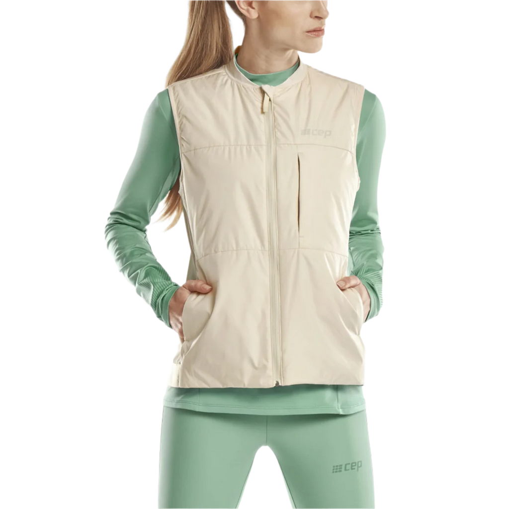 CEP Cold Weather Reversible Vest. Women's. Cream. Front view on model.