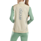 CEP Cold Weather Reversible Vest. Women's. Cream. Back view on model.