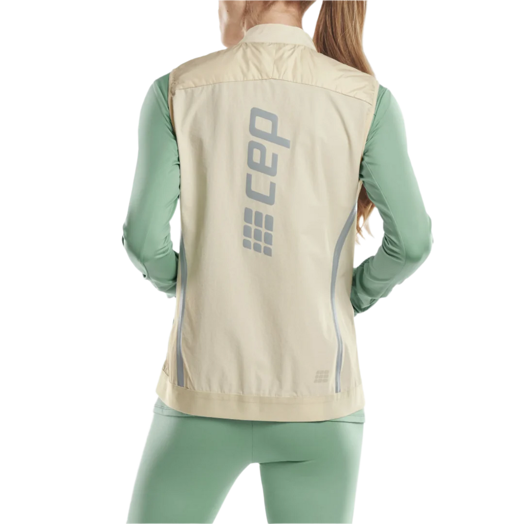 CEP Cold Weather Reversible Vest. Women's. Cream. Back view on model.