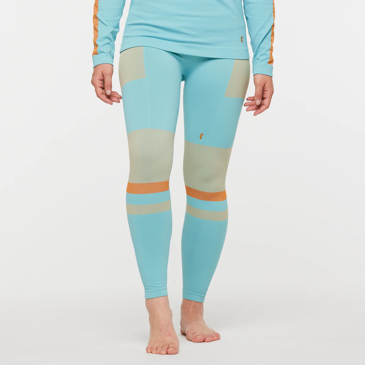 Women's Cotopaxi Debajo Seamless Baselayer Tights. Blue, tan, and orange pattern. Front view. 