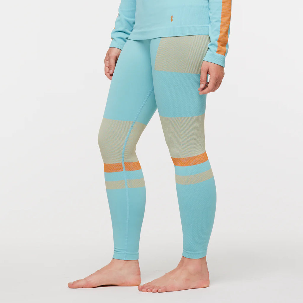 Women's Cotopaxi Debajo Seamless Baselayer Tights. Blue, tan, and orange pattern. Lateral view.